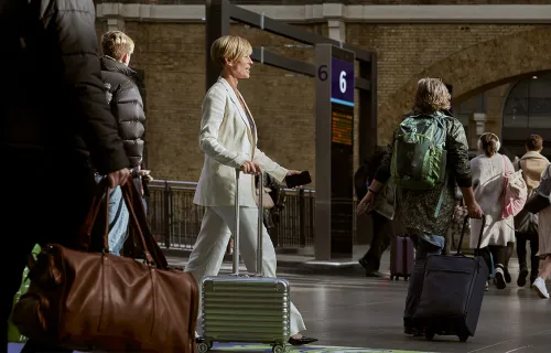 Platform of platforms by ServiceNow. Image: People walking across a railway station.